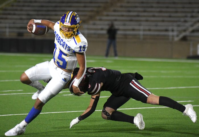 Sunray's Armando Lujan avoids a tackle from New Home's Graham Keys in a Class 2A Division II area-round game Nov. 17, 2023, at Happy State Bank Stadium in Canyon.